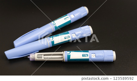 Ozempic Insulin injection pen on a dark background for diabetics and weight loss. 123589592