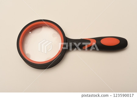Magnifying glass on a white background. A magnification device for the visually impaired. Magnifying glass on a white background. A magnification device for the visually impaired. 123590017