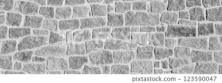Black and white close-up of an irregular stone wall. The rough texture and natural patterns create a rustic and historical appearance. Ideal for backgrounds, textures. Long banner. Black and white close-up of an irregular stone wall. The rough texture and natural patterns create a rustic and historical appearance. Ideal for backgrounds, textures. Long banner. 123590047