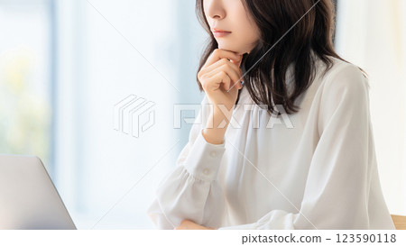一位女士/女商人一邊看著電腦螢幕一邊思考 一位女士/女商人一邊看著電腦螢幕一邊思考 123590118