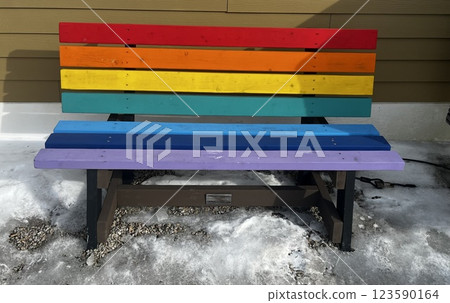 A colorful rainbow painted bench outside A colorful rainbow painted bench outside 123590164