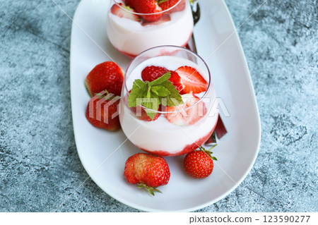 Red strawberries with whipped cream dessert on blue background 123590277