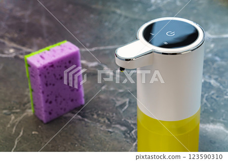 White dishwashing liquid dispenser on dark marble countertop White dishwashing liquid dispenser on dark marble countertop 123590310