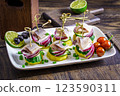 Plate of small sandwiches with herring, potatoes and onions 123590311