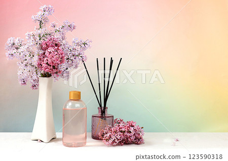 Spa and wellness composition with lilac water, pink salt, aromatic sticks and fresh lilac flowers, spa salon advertising card with space for text. Concept of natural self-care and healthy lifestyle, 123590318