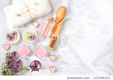 Spa and wellness composition with lilac water, pink salt, aromatic sticks and fresh lilac flowers, spa salon advertising card with space for text. Concept of natural self-care and healthy lifestyle, Spa and wellness composition with lilac water, pink salt, aromatic sticks and fresh lilac flowers, spa salon advertising card with space for text. Concept of natural self-care and healthy lifestyle, 123590322