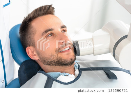 Patient has a spot X-ray taken Patient has a spot X-ray taken 123590731