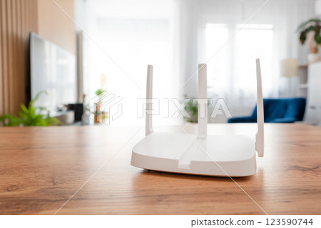 Modern wi-fi router on light table in room Modern wi-fi router on light table in room 123590744