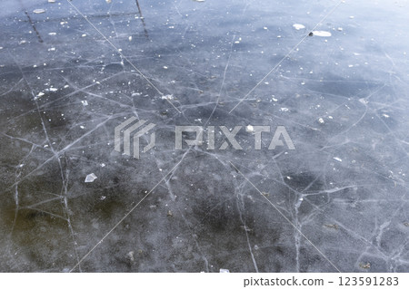 walking on transparent ice covering a frozen winter river 123591283