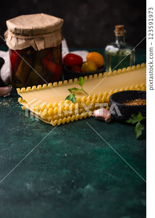 Uncooked lasagna pasta with cooking ingredient 123591973