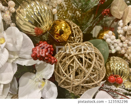Christmas tree decoration with ornaments and orchids, close up. New Year and Christmas celebration concept Christmas tree decoration with ornaments and orchids, close up. New Year and Christmas celebration concept 123592296
