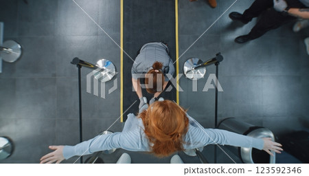 Diverse People Walking Through X-ray Metal Detector, Security Officers Inspecting Passengers 123592346