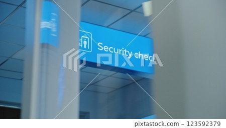 Airport Terminal: Bright LED Blue Security Checkpoint Sign Indicates the Location for Passengers Screening Airport Terminal: Bright LED Blue Security Checkpoint Sign Indicates the Location for Passengers Screening 123592379