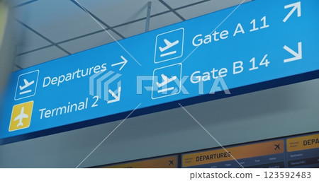 International Airport Terminal: Big Blue Navigation Sign Directing Passengers to Gates 123592483
