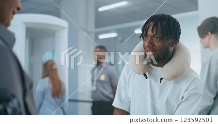 Security Checkpoint in Airport: Multiethnic Travelers Putting Personal Items for X-ray Scanning 123592501