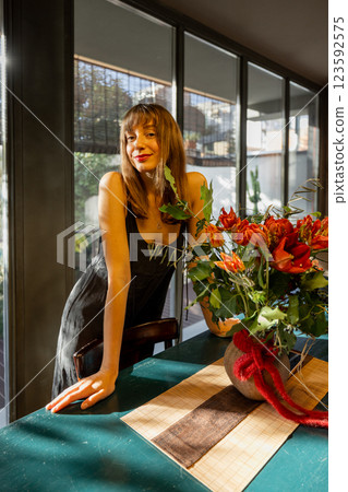 Smiling Woman in a Bright Modern Kitchen 123592575