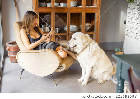 Woman Relaxing in Vintage Kitchen with Dog Woman Relaxing in Vintage Kitchen with Dog 123592598