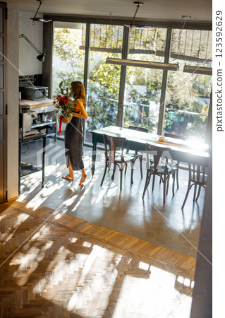 Woman Walking in Sunlit Modern Interior 123592629
