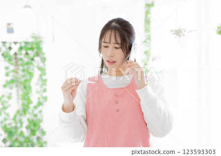 A woman contacting the office because her child has a fever 123593303