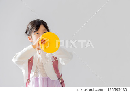 First grader in elementary school that supports megaphone First grader in elementary school that supports megaphone 123593483