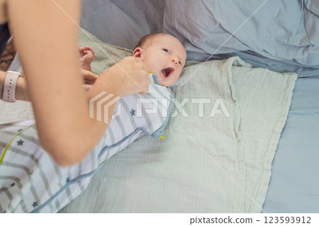 A newborn baby rests snugly in a cozy sleep cocoon, feeling secure and comforted before drifting off to sleep. A peaceful moment of relaxation, warmth, and gentle care, symbolizing restful sleep and A newborn baby rests snugly in a cozy sleep cocoon, feeling secure and comforted before drifting off to sleep. A peaceful moment of relaxation, warmth, and gentle care, symbolizing restful sleep and 123593912