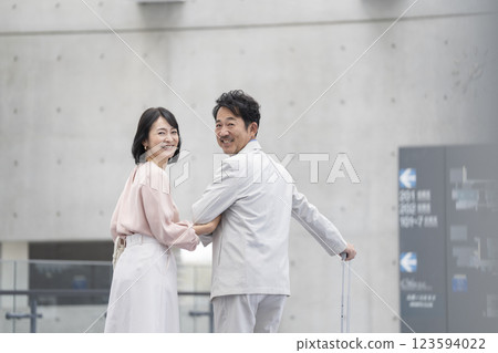 A couple in their 50s looking back with a smile A couple in their 50s looking back with a smile 123594022