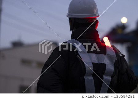 A worker directing traffic A worker directing traffic 123594281