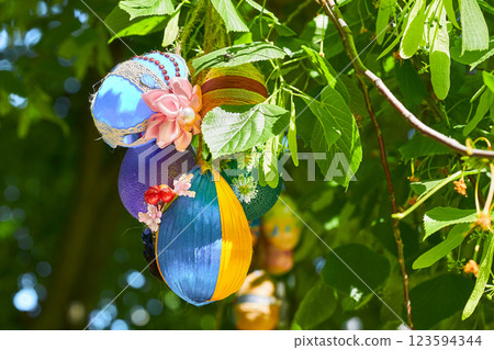 Spring blue yellow colorful painted Easter eggs on green tree Spring blue yellow colorful painted Easter eggs on green tree 123594344