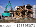Demolition of vacant houses using heavy machinery Demolition of a dilapidated wooden house 123595071