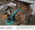 Demolition of vacant houses using heavy machinery Demolition of a dilapidated wooden house 123595072
