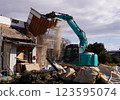 Demolition of vacant houses using heavy machinery Demolition of a dilapidated wooden house 123595074