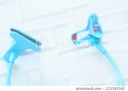 Blur fixate.Blue flexible holder with a clamp for a phone, something Blur fixate.Blue flexible holder with a clamp for a phone, something 123595162