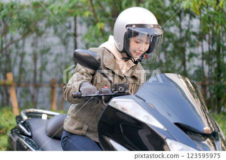 Young woman riding a motorcycle Young woman riding a motorcycle 123595975