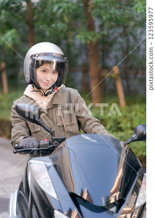 Young woman riding a motorcycle Young woman riding a motorcycle 123595977