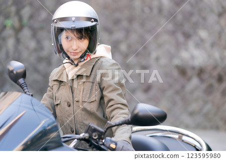 Young woman riding a motorcycle 123595980