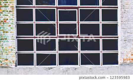 Black window with white frames on vintage old brick wall 123595983
