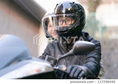 A man and a woman riding on a motorcycle A man and a woman riding on a motorcycle 123596448