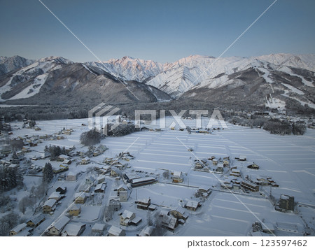 The beautiful morning glow of Mt. Goryu and Mt. Karamatsu and the townscape of Hakuba Village, Nagano Prefecture (aerial photography by drone) The beautiful morning glow of Mt. Goryu and Mt. Karamatsu and the townscape of Hakuba Village, Nagano Prefecture (aerial photography by drone) 123597462