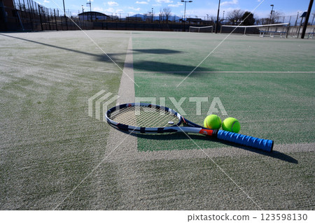 Racket and ball on a tennis court 123598130