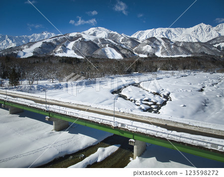 Beautiful view of the Hakuba mountain range and Matsukawa River, Hakuba Village, Nagano Prefecture (aerial shot by drone) 123598272