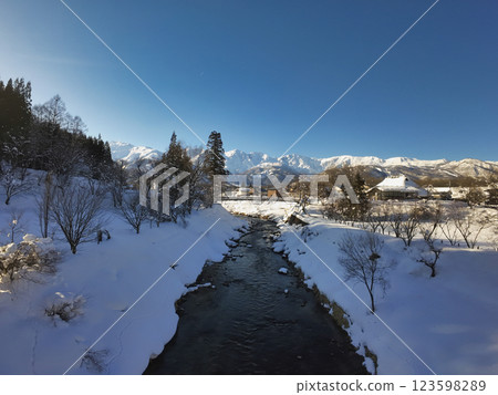 Oide Suspension Bridge and the Hakuba Sanzan mountains, Hakuba Village, Nagano Prefecture (aerial photography by drone) 123598289