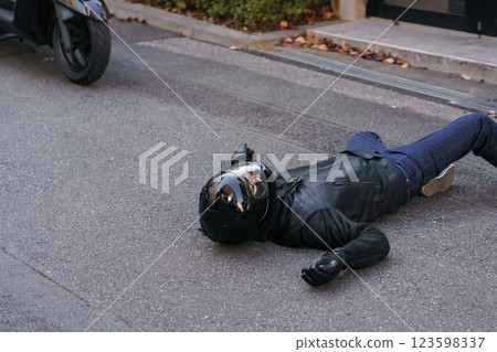 Motorcycle accident and person lying on the road 123598337
