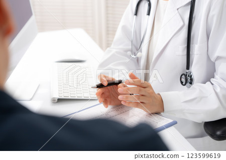Image of a female doctor examining a patient Image of a female doctor examining a patient 123599619