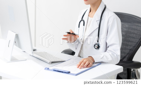 Image of a female doctor examining a patient Image of a female doctor examining a patient 123599621