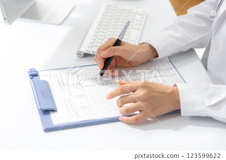 Image of a female doctor examining a patient 123599622