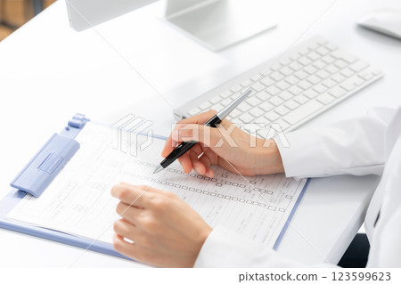 Image of a female doctor examining a patient 123599623