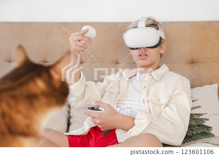 Teen Boy Exploring Virtual Reality on Bed. Teen Boy Exploring Virtual Reality on Bed. 123601106