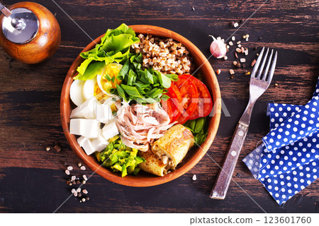 Delicious healthy breakfasts, buckwheat with boiled egg and meat and cheese on plate 123601760