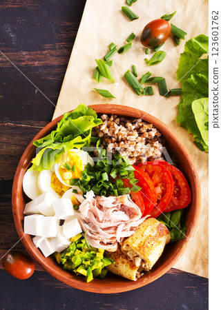 Delicious healthy breakfasts, buckwheat with boiled egg and meat and cheese on plate 123601762