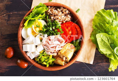 Delicious healthy breakfasts, buckwheat with boiled egg and meat and cheese on plate 123601764